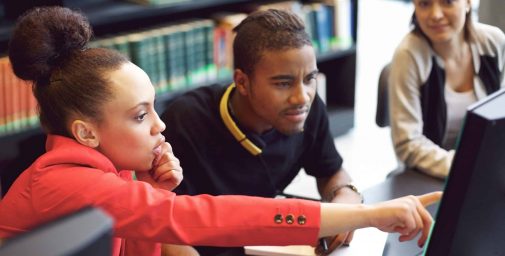 Small,Group,Of,University,Students,Working,On,Computer,In,A Small,Group,Of,University,Students,Working,On,Computer,In,A